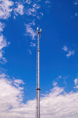 Obraz premium Modern telecommunications tower reaching into a blue sky