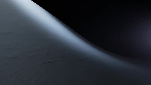 Abstract dark interior concept based on minimal dark wall, monolithic black surface curving gently within a shadowed studio environment, single cool spotlight grazing across the curve to reveal soft