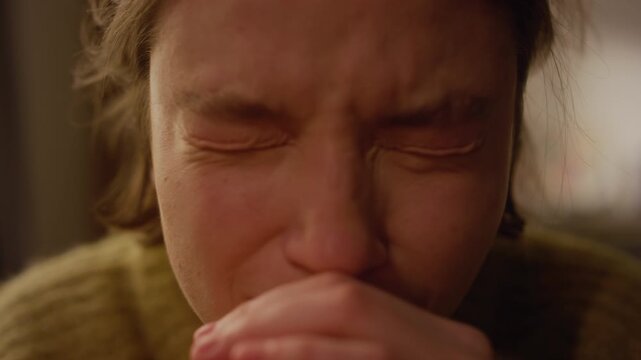 Close up portrait shot of nervous young adult woman making quick eye movements while crying then looking straight to camera sitting in indoors