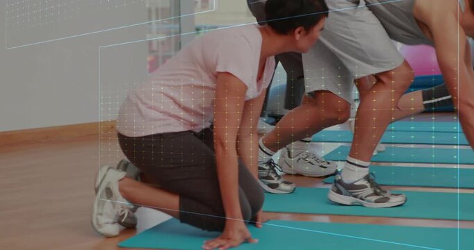 Participant stepping, fitness class holding plank flow on blue mats with animated cues for strength
