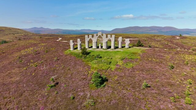 Drone Footage of Fyrish Monument Landmark, Scottish Highland Scenery, Purple Moorland, and Historic Stone Structures.