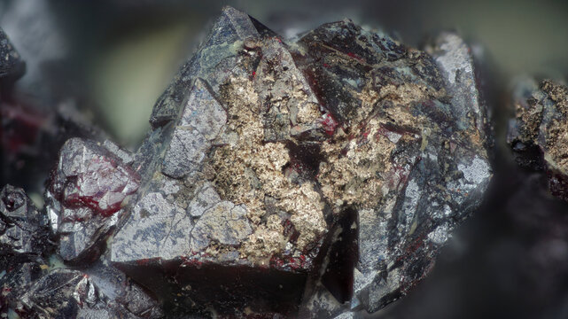 Macro photograph of native silver metallic deposits on cuprite crimson octahedral formations from Altai, Russia, via microscope, 12x magnification, 3mm field of view