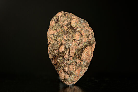 Macro frozen in stone: rounded pink feldspar clasts within gray marine matrix from White Sea, Arctic Russia, via microscope, 5x magnification, 7.2mm field of view, focus stacking