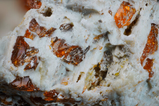 Macro image of calcite white matrix with orange translucent sphalerite crystals from Khatanga River, Siberia, via microscope, 10x magnification, 3.6mm view