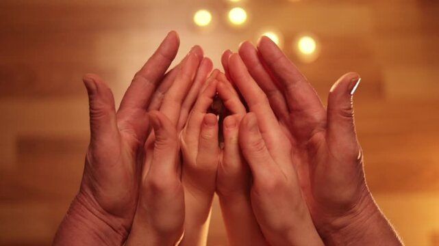 three woman`s hands are folded in a prayer gesture open alternately and there is a snowdrop in the last children`s pen