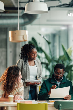 Business colleagues collaborating on project in modern office