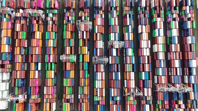 Rotterdam, Netherlands. Drone shot of modern industrial container port of Rotterdam with containers from top view. It is an import and export cargo port where is a part of shipping dock