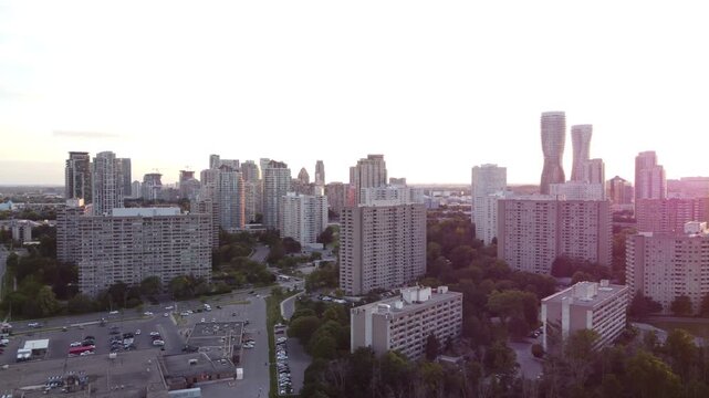 Aerial shot of the downtown city of Mississauga, Ontario, Canada skyline during late afternoon. Sun low in the sky, with some lens flare.