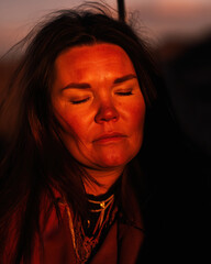 Fototapeta premium Portrait of woman with eyes closed in warm light