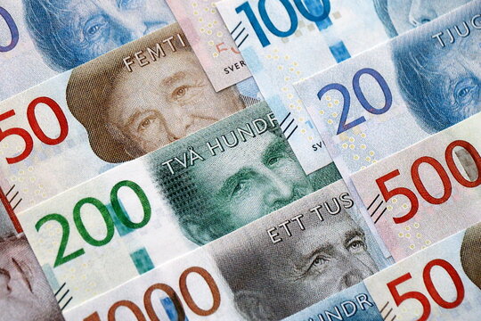 Swedish krona paper banknotes pile on table. Sweden SEK currency money bills in big amount. Concept of economics, taxation and banking in Sweden