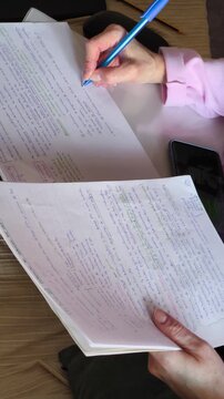 Woman using smartphone while writting on sofa