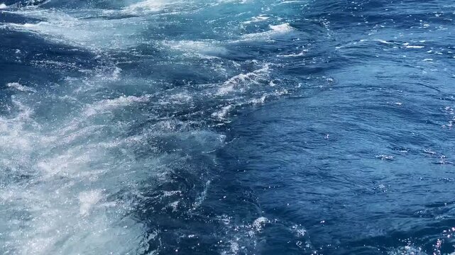 Tourist boat sailing along the Amalfi coast with amazing mountain cliffs view, sparkling wake on crystal clear blue water surface, enjoying Amalfi and Positano from speedboat during summer vacation