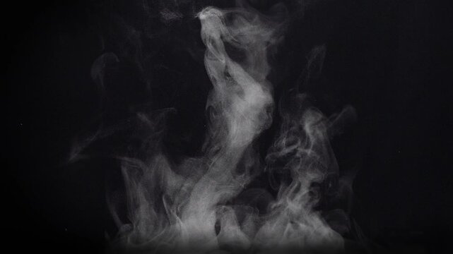 White natural rising steam from food or hot drink isolated on a black background. Сan be used in any projects with hot food.