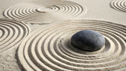 Papier peint photo Beige japanese zen garden featuring dark rounded stone centered within concentric circular raked sand patterns light beige texture minimalist aesthetic peaceful meditative atmosphere  © Natalia