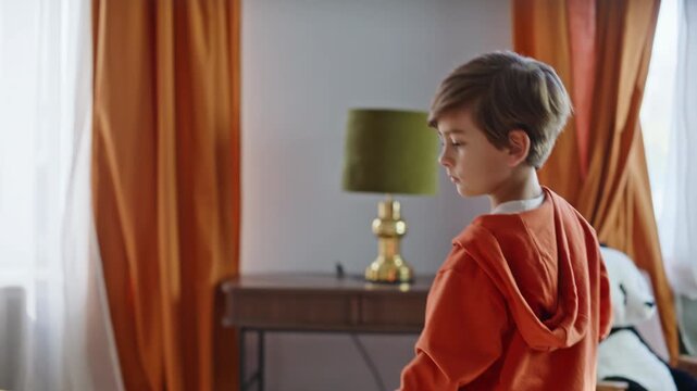 Little helper vacuuming home cleaning couch closeup. Boy using vacuum cleaner