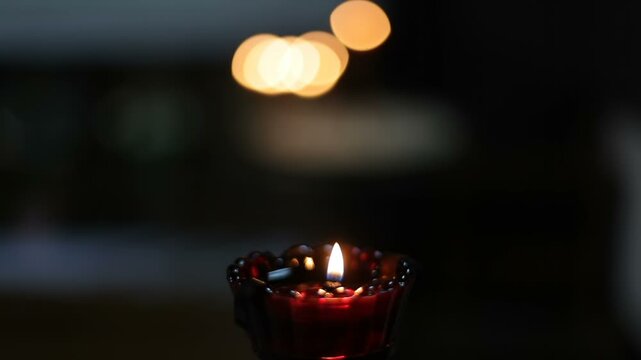 The church lamp burns in the dark.