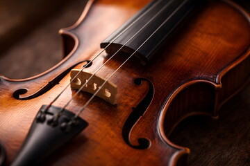 Fototapeta premium Close up view of a classical violin showing elegant wooden texture and strings.