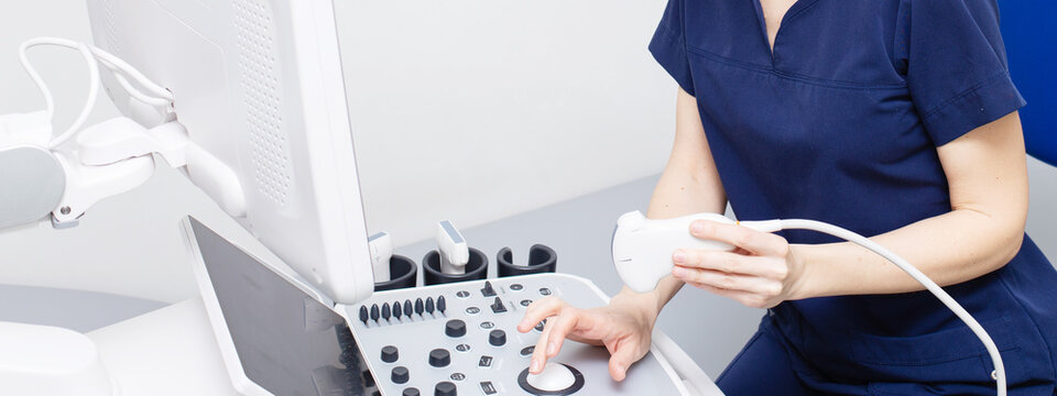 Female doctor sitting in office in a hospital doing ultrasound scanning diagnostic