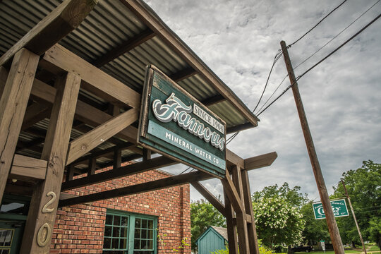 Famous Mineral Water Since 1904 Sign on Building With Cloudy Sky in Mineral Wells, Texas