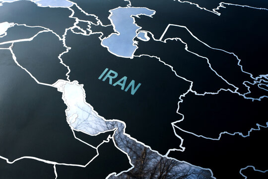 Minimalist dark map of Iran with light blue accents on the Caspian Sea and Persian Gulf. Geopolitical concept for Middle East news, global politics and international relations.