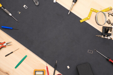 Electronic repair tools and equipment on workbench with copy space