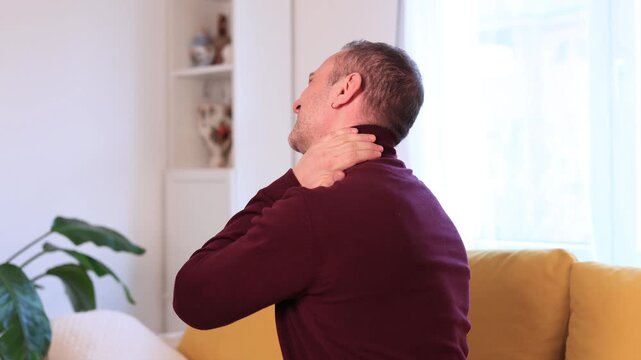 Man with neck, muscle, back and sciatica pain at home.