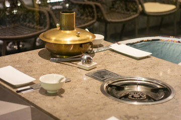 Hot pot table setting with brass pot and built-in burner