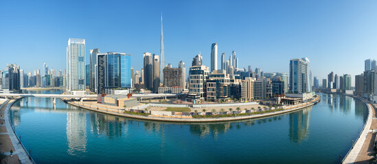 Panoramic skyline of Dubai with modern skyscrapers and futuristic architecture at sunset. Iconic cityscape of the largest city in the United Arab Emirates, famous for luxury tourism, business district