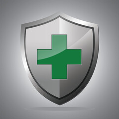 Obraz premium Metallic shield with green medical cross.