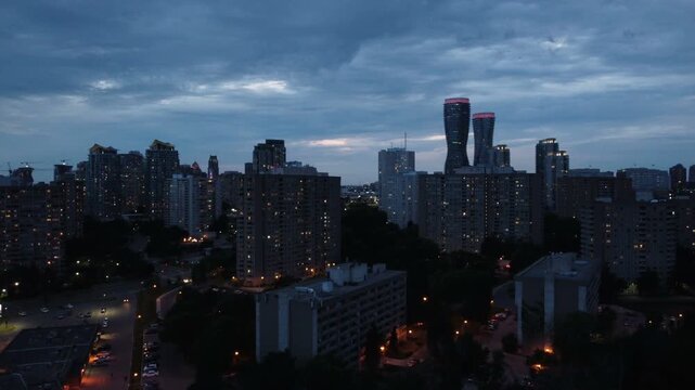 Aerial shot of the downtown city of Mississauga, Ontario, Canada skyline during evening dusk, moving up.
