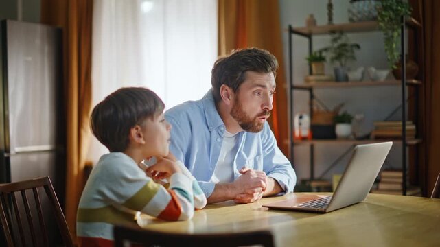 Dad boy enjoy webchat communication sitting kitchen closeup. Father son talking