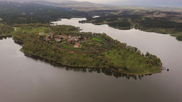 Aerial view of the ruins of Granadilla, a fortified medieval village in C&aacute;ceres, Spain, surrounded by Gabriel y Gal&aacute;n Reservoir. Historic walled town with castle tower and rural landscape in western I
