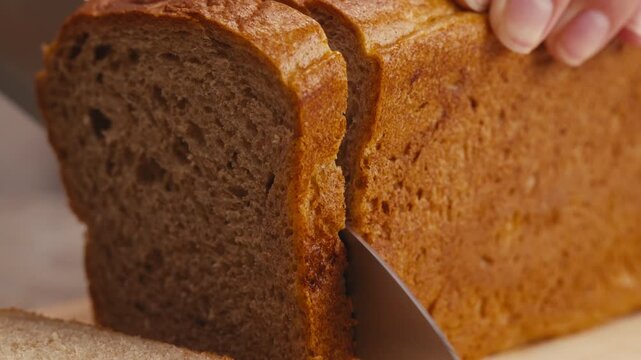 Black rye bread close up, dark brown sliced loaf, borodinsky slavic food, square slices with coriander on white background