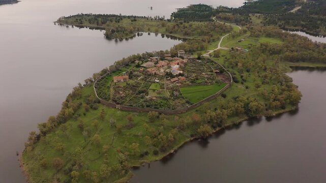 Aerial view of the ruins of Granadilla, a fortified medieval village in C&aacute;ceres, Spain, surrounded by Gabriel y Gal&aacute;n Reservoir. Historic walled town with castle tower and rural landscape in western I