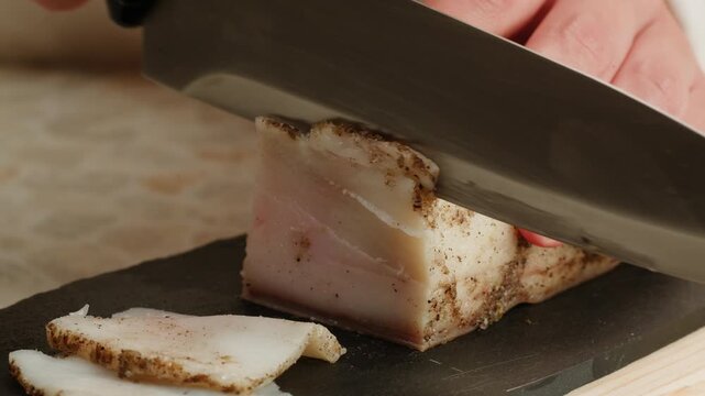 Salted lard bacon pork meat slicing in restaurant on kitchen, salo macro pork fat, black bread sandwich decorated with dill on white background close-up. Healthy fats. Healthy food. Vitamins