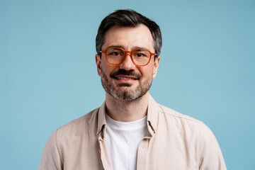 Fototapeta premium Confident man in glasses smiling at camera, adult bearded male portrait