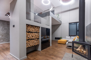 Fototapeta premium Modern architectural design of the interior space of a country house in the high-tech style. White decor, straight lines, glass partitions. Recreation area with modern furniture.