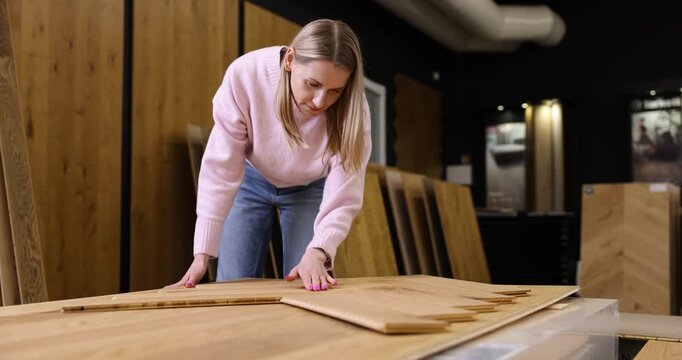 woman choosing parquet design in flooring shop