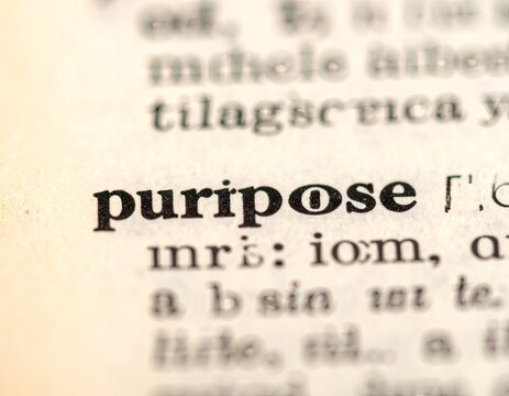 A close-up shot focuses on the word 'purpose' highlighted within an aged, vintage dictionary, evoking themes of intention, meaning, and the exploration of language's depth.
