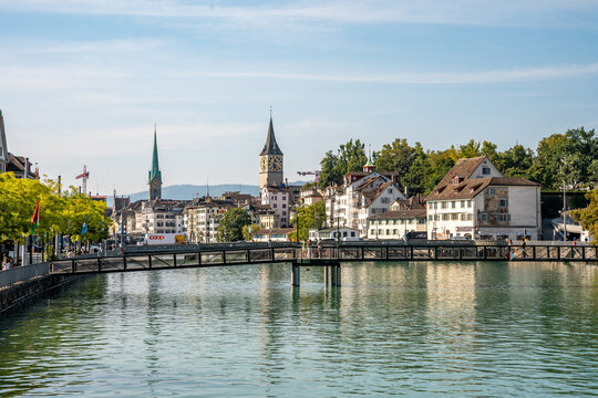 Scenic city view with church bell towers and the Limmat river seen from Muhlesteg bridge in Zurich, Switzerland.