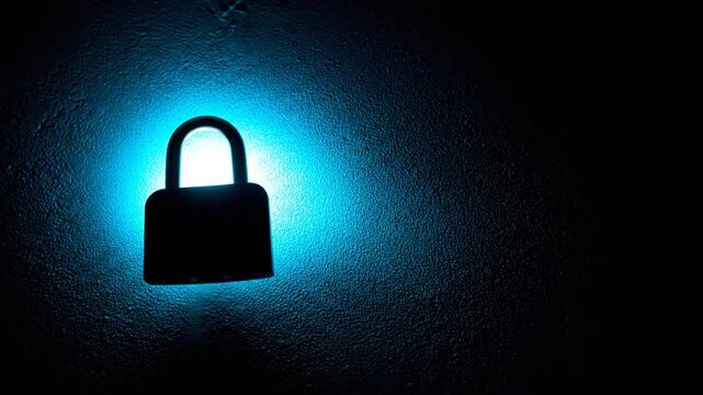 A silhouette of a padlock against a textured background illuminated by a bright blue light