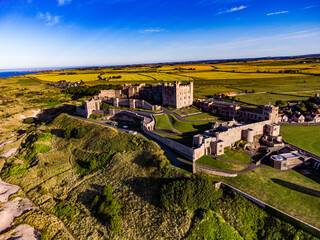 Bamburgh Castle, a striking medieval fortress located on the coast of Northumberland, England.  © Stuart