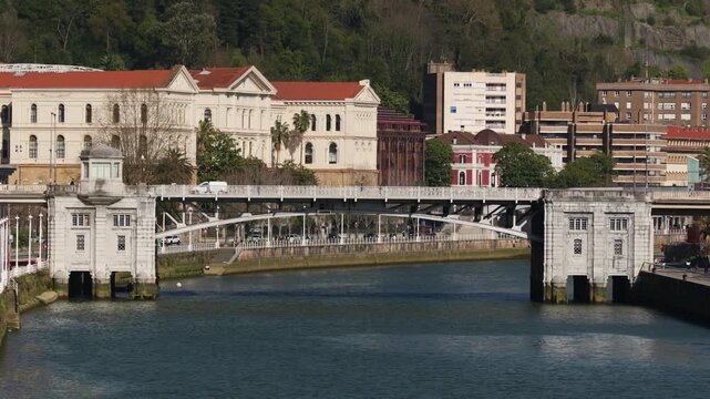 Sunny view of the Nervi&oacute;n River with the Deusto Bridge connecting the Deusto district and Plaza Euskadi in Bilbao Spain