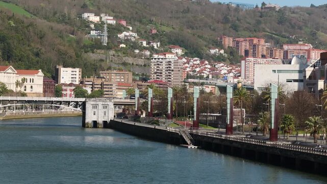 Sunny view of the Nervi&oacute;n River with the Deusto Bridge connecting the Deusto district and Plaza Euskadi in Bilbao Spain