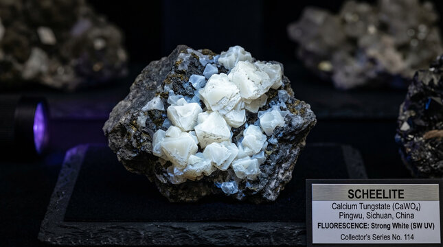 Macro photo of scheelite tungsten calcium tungstate mineral with fluorescent white luster, UV-reactive mineral concept for science brand or collector editorial, no faces