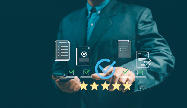 Businessman interacting with digital interface showing checked documents and a 5-star rating system, symbolizing document evaluation, quality control, feedback, and business performance assessment.