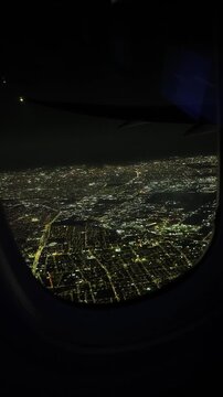 Aerial Night City Lights Seen from Airplane Windo