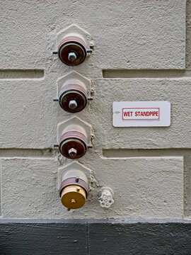 Stack of four wet standpipes on concrete wall