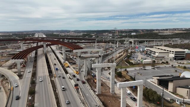 View of Interstate 10 and Loop 1604 highway interchange under construction with traffic in San Antonio, Texas 4K Aerial Drone Video