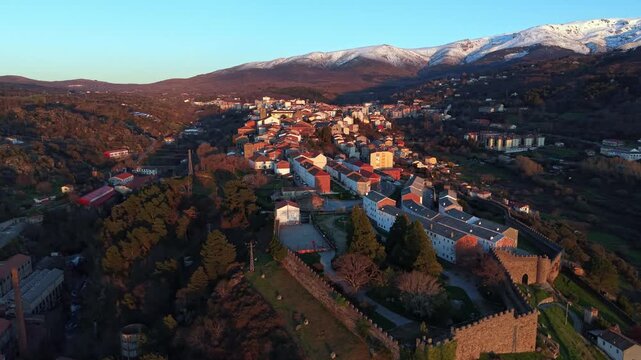 Aerial images of Bejar in the province of Salamanca with the Sierra Nevada mountains in the background during sunset, 4k 30fps 1 inch sensor DJI, drone image